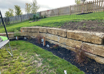 stone retaining wall with landscaping